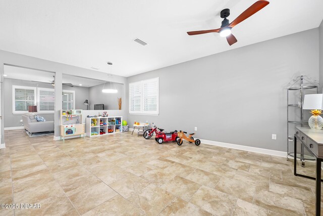 rec room with ceiling fan, visible vents, and baseboards