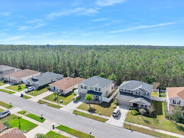 birds eye view of property featuring a residential view and a view of trees