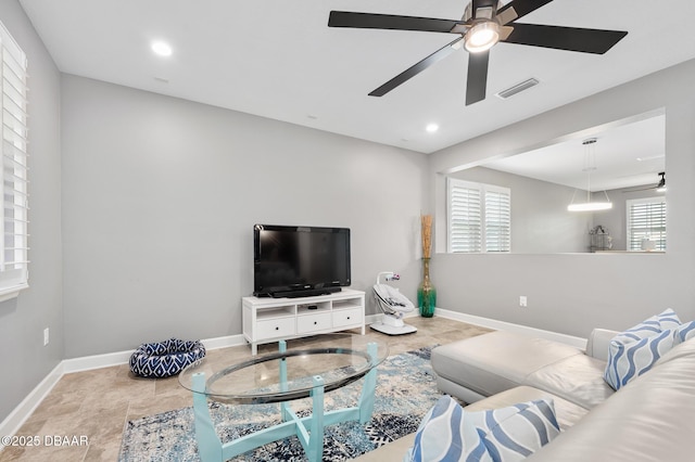 living room featuring a ceiling fan, recessed lighting, visible vents, and baseboards