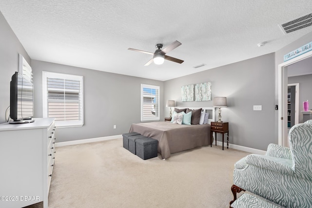 bedroom featuring light carpet, ceiling fan, visible vents, and baseboards