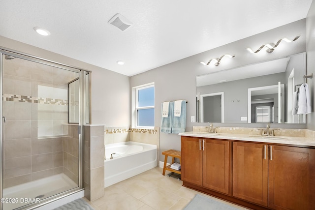 full bath with a stall shower, visible vents, a garden tub, tile patterned flooring, and a sink