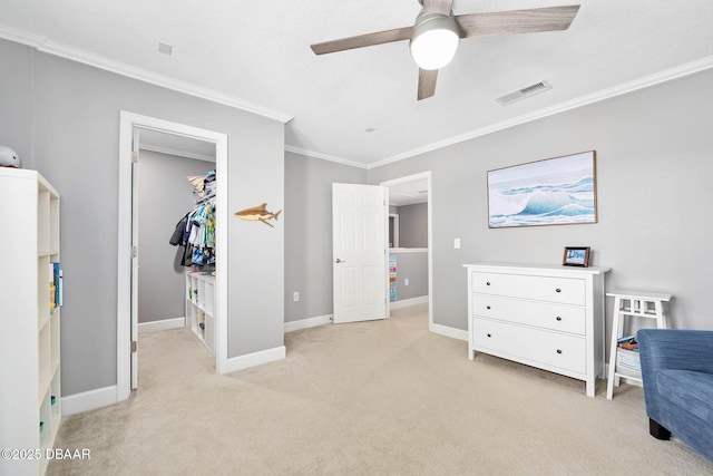 bedroom featuring light carpet, visible vents, baseboards, ornamental molding, and a walk in closet