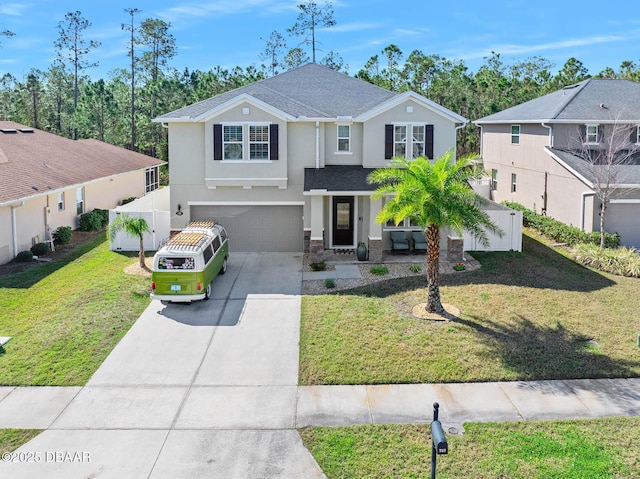 traditional-style house with stucco siding, concrete driveway, an attached garage, fence, and a front lawn