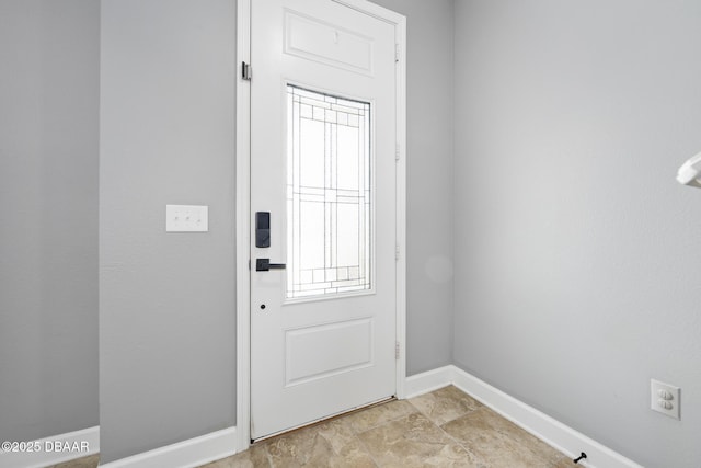 doorway featuring baseboards