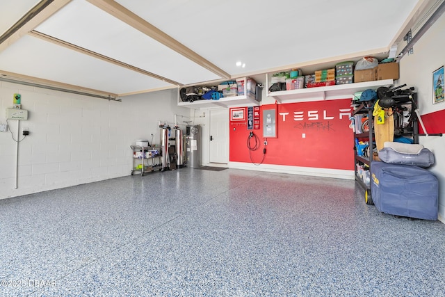 garage with water heater and concrete block wall