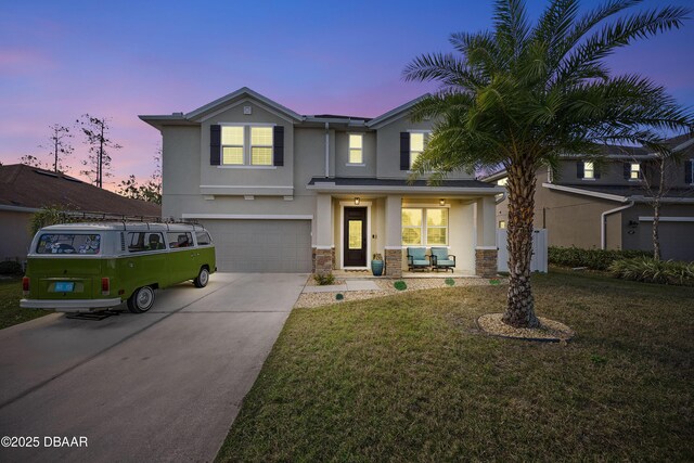 view of front facade featuring a garage and a yard