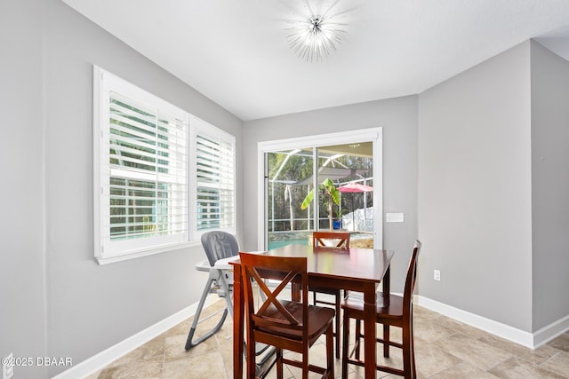 dining area featuring baseboards