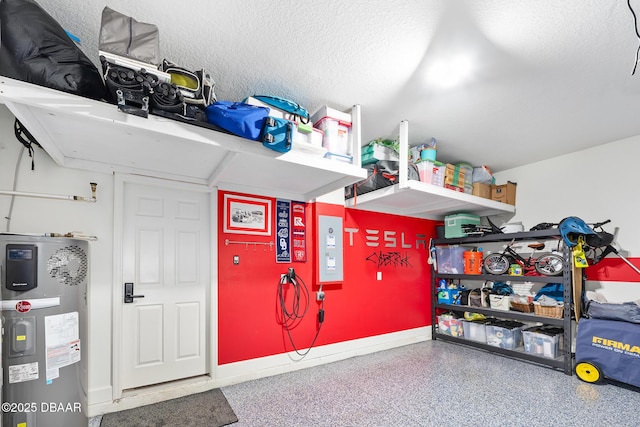 garage with heat pump water heater and baseboards