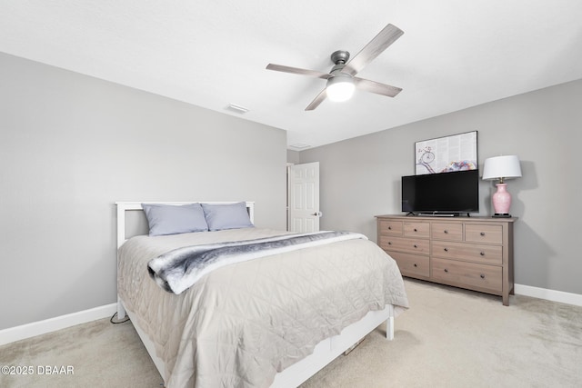 bedroom featuring baseboards, a ceiling fan, visible vents, and light colored carpet