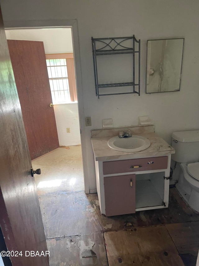 bathroom featuring vanity and toilet