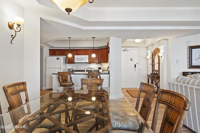 200 Ocean Crest Dr Unit 705, Palm Coast, FL 32137 - dining space featuring a tray ceiling and light wood-style floors