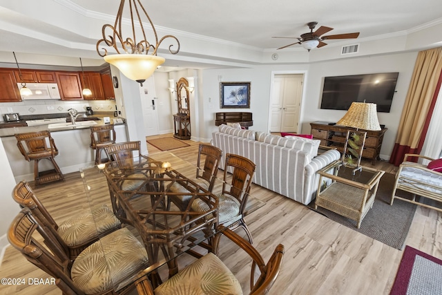 200 Ocean Crest Dr Unit 705, Palm Coast, FL 32137 - dining room featuring a ceiling fan, light wood-style flooring, and ornamental molding