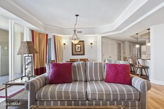200 Ocean Crest Dr Unit 705, Palm Coast, FL 32137 - living room with a raised ceiling, wood finished floors, and crown molding