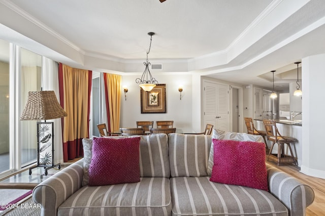 200 Ocean Crest Dr Unit 705, Palm Coast, FL 32137 - living room featuring a tray ceiling, wood finished floors, and crown molding