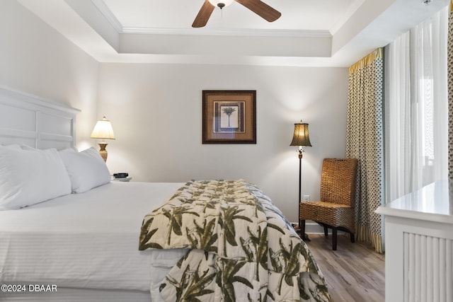 200 Ocean Crest Dr Unit 705, Palm Coast, FL 32137 - bedroom with a tray ceiling, ornamental molding, wood finished floors, and a ceiling fan