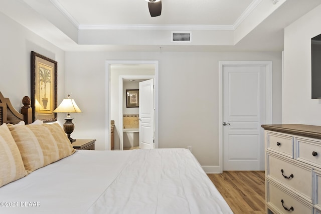 200 Ocean Crest Dr Unit 705, Palm Coast, FL 32137 - bedroom with a raised ceiling, light wood-style floors, crown molding, and ensuite bathroom