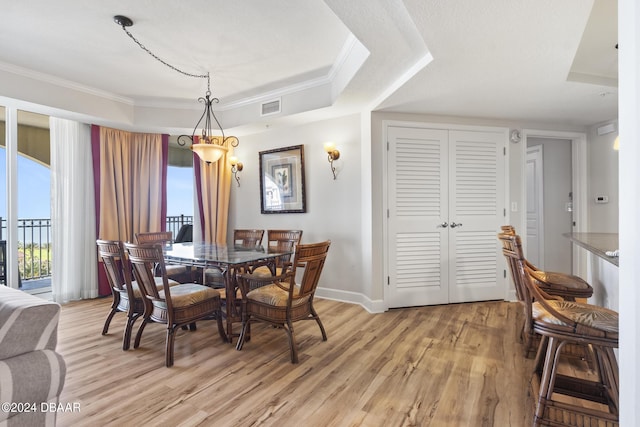 200 Ocean Crest Dr Unit 705, Palm Coast, FL 32137 - dining room with light wood-style flooring, crown molding, and a tray ceiling