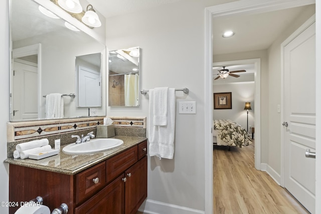 200 Ocean Crest Dr Unit 705, Palm Coast, FL 32137 - full bath with vanity, wood finished floors, a ceiling fan, and a shower with shower curtain