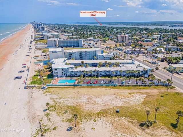 drone / aerial view with a water view and a view of the beach