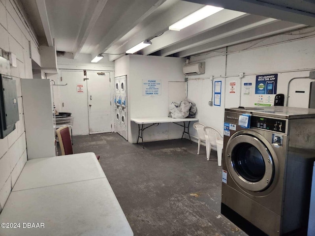 community laundry room with separate washer and dryer, a wall mounted AC, and stacked washer / drying machine