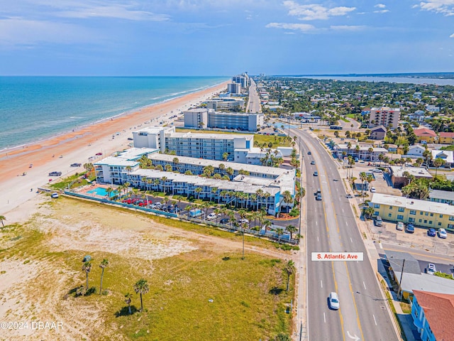 drone / aerial view with a water view and a beach view