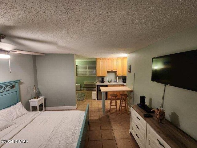 bedroom featuring tile patterned flooring and a textured ceiling