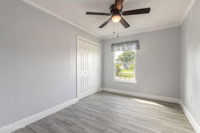 991 Dawson Dr, Deltona, FL 32725 - unfurnished room featuring a textured ceiling, ornamental molding, wood finished floors, a ceiling fan, and baseboards