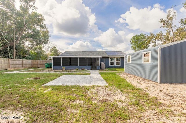 991 Dawson Dr, Deltona, FL 32725 - back of house featuring a sunroom and a patio