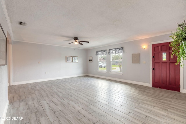 991 Dawson Dr, Deltona, FL 32725 - unfurnished living room featuring a textured ceiling, a ceiling fan, ornamental molding, light wood finished floors, and baseboards