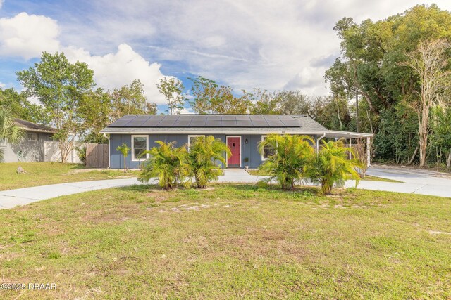 991 Dawson Dr, Deltona, FL 32725 - view of front of house with driveway, roof mounted solar panels, and board and batten siding