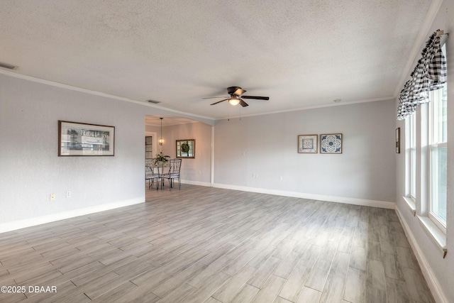 991 Dawson Dr, Deltona, FL 32725 - unfurnished living room with a textured ceiling, ceiling fan, light wood-style flooring, baseboards, and crown molding