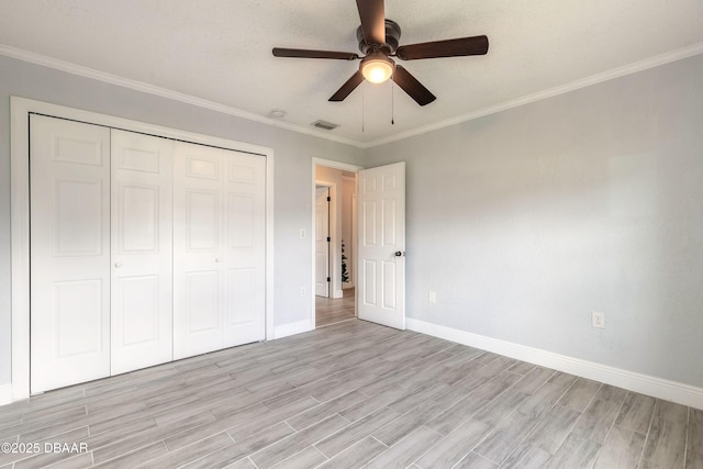 991 Dawson Dr, Deltona, FL 32725 - unfurnished bedroom with light wood-style floors, baseboards, a closet, ornamental molding, and ceiling fan