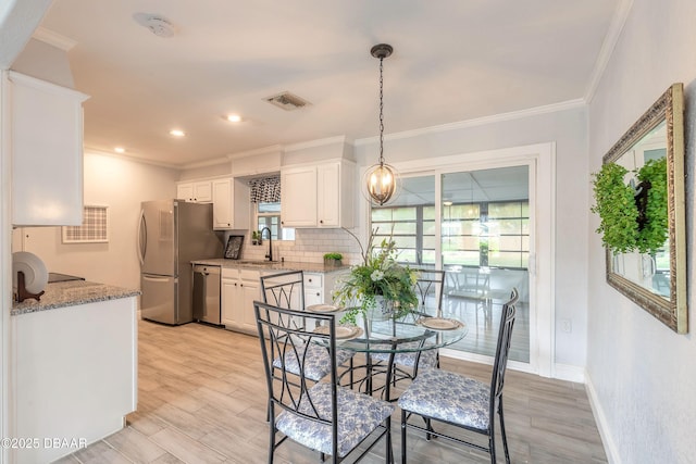 991 Dawson Dr, Deltona, FL 32725 - dining space with ornamental molding, light wood-type flooring, baseboards, and recessed lighting