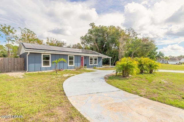 991 Dawson Dr, Deltona, FL 32725 - single story home with board and batten siding, roof mounted solar panels, and curved driveway