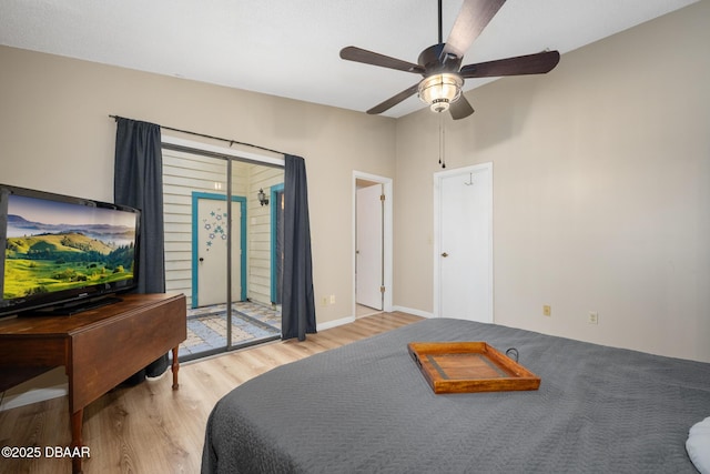 bedroom with access to outside, wood finished floors, a ceiling fan, and baseboards