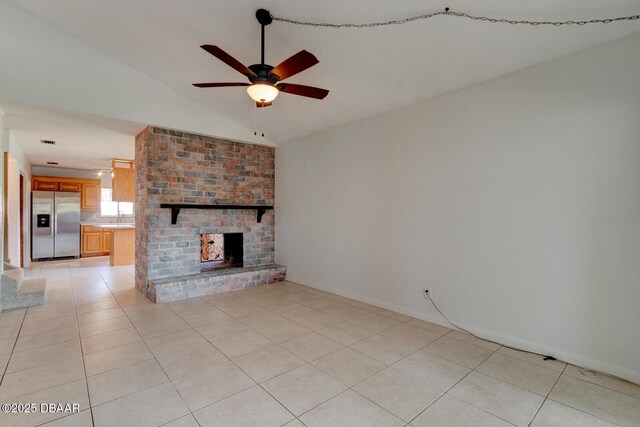 909 Northbrook Dr, Ormond Beach, FL 32174 - unfurnished living room featuring a ceiling fan, lofted ceiling, light tile patterned floors, and a fireplace