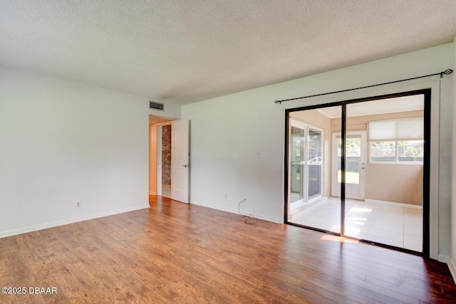 909 Northbrook Dr, Ormond Beach, FL 32174 - spare room with wood finished floors and a textured ceiling