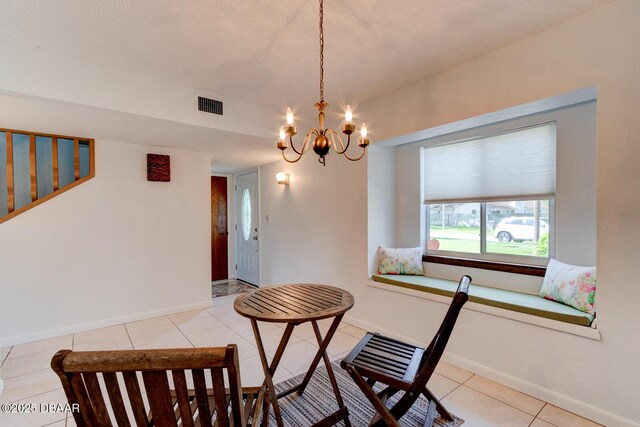 909 Northbrook Dr, Ormond Beach, FL 32174 - dining space with a chandelier and light tile patterned floors