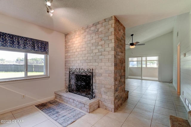 909 Northbrook Dr, Ormond Beach, FL 32174 - unfurnished living room with light tile patterned floors, a textured ceiling, a ceiling fan, vaulted ceiling, and a fireplace