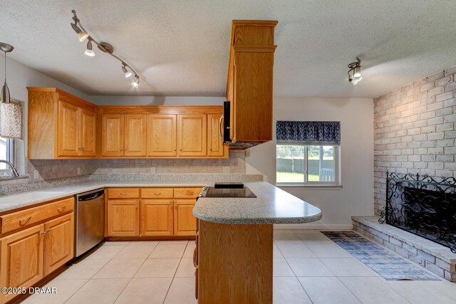 909 Northbrook Dr, Ormond Beach, FL 32174 - kitchen featuring appliances with stainless steel finishes, a peninsula, a textured ceiling, track lighting, and light tile patterned flooring