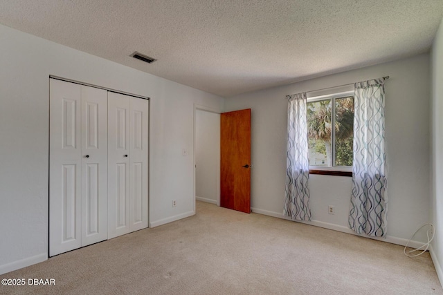 909 Northbrook Dr, Ormond Beach, FL 32174 - unfurnished bedroom featuring carpet floors, a closet, and a textured ceiling