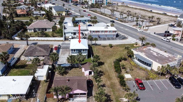 birds eye view of property with a beach view and a water view