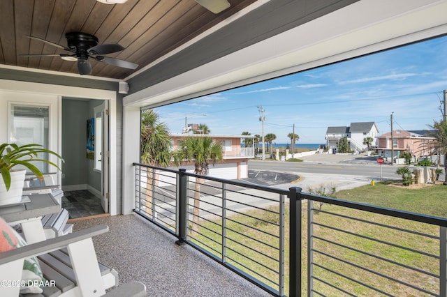 balcony featuring ceiling fan and a residential view