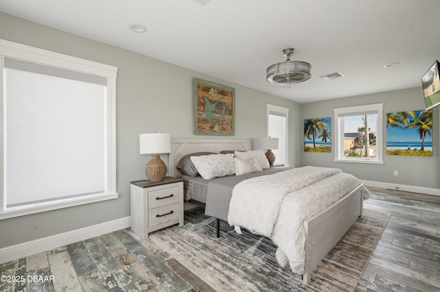 bedroom featuring baseboards, visible vents, and dark wood finished floors