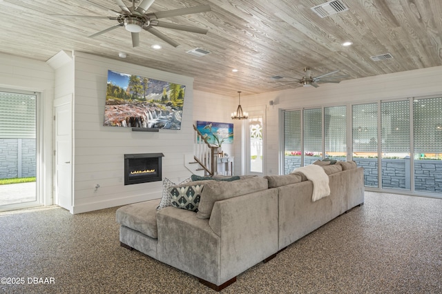 living room featuring wood ceiling, visible vents, and a wealth of natural light