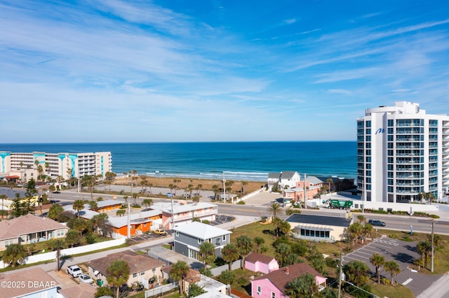 bird's eye view with a water view and a beach view