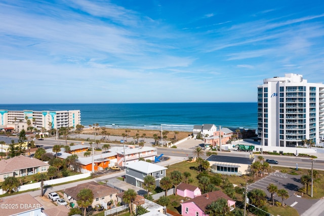bird's eye view featuring a water view and a beach view