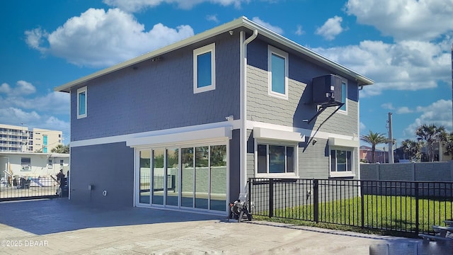 back of house with a fenced front yard