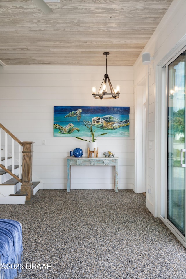 interior space featuring stairway and an inviting chandelier