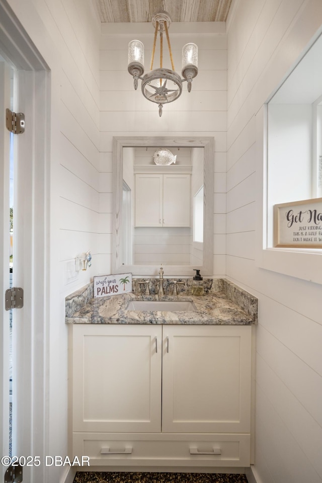 bathroom with a chandelier and vanity